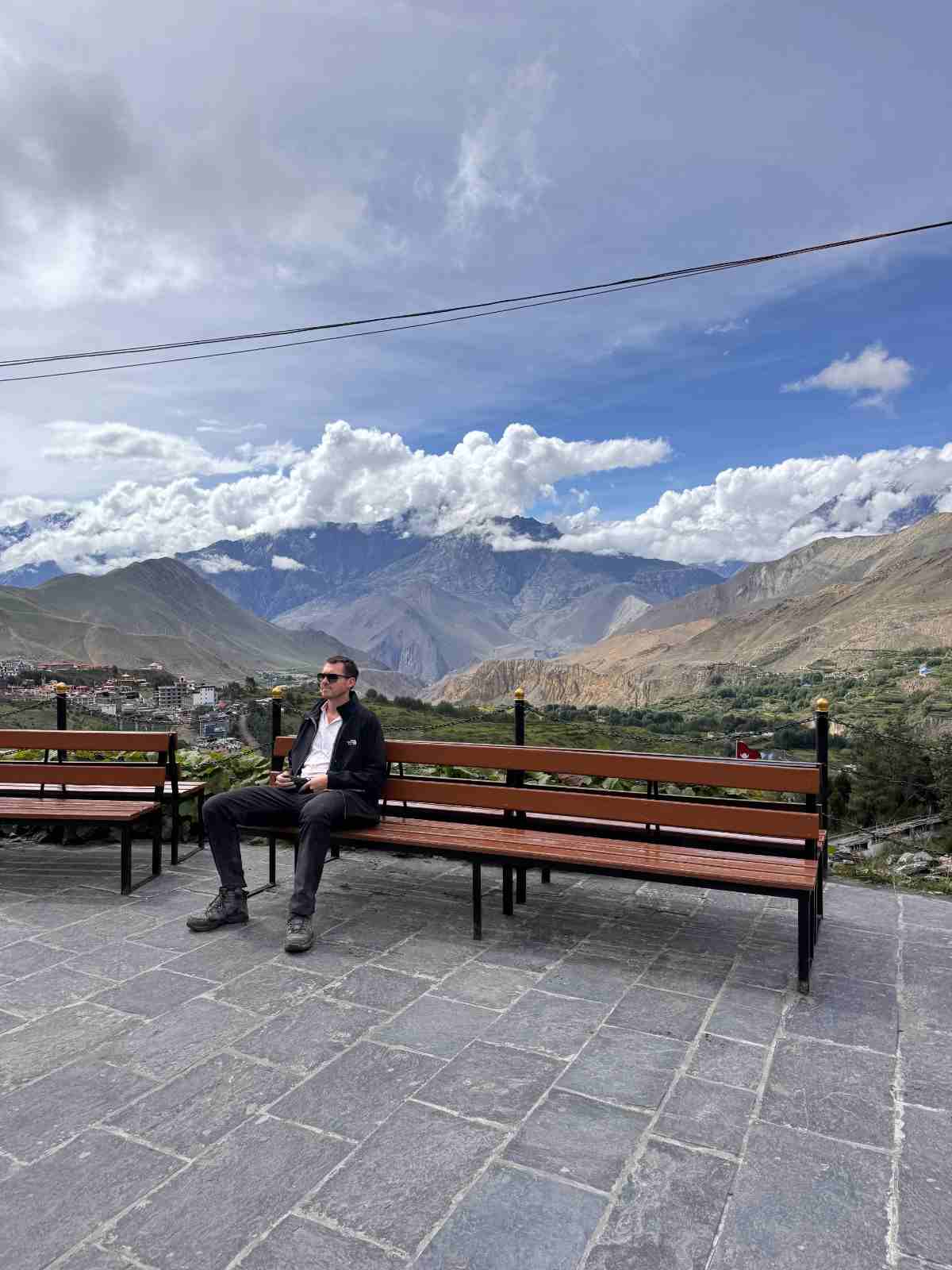 202609270915 Guest Sitting On A Bench Around Muktinath Temple
